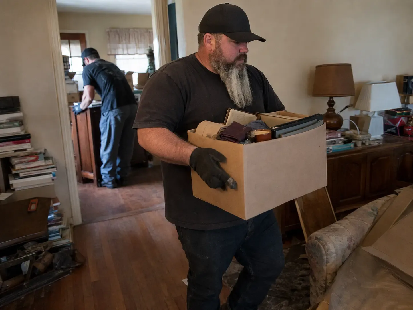 Chums Junk Removal team carrying furniture during an estate cleanout in Northwest Arkansas