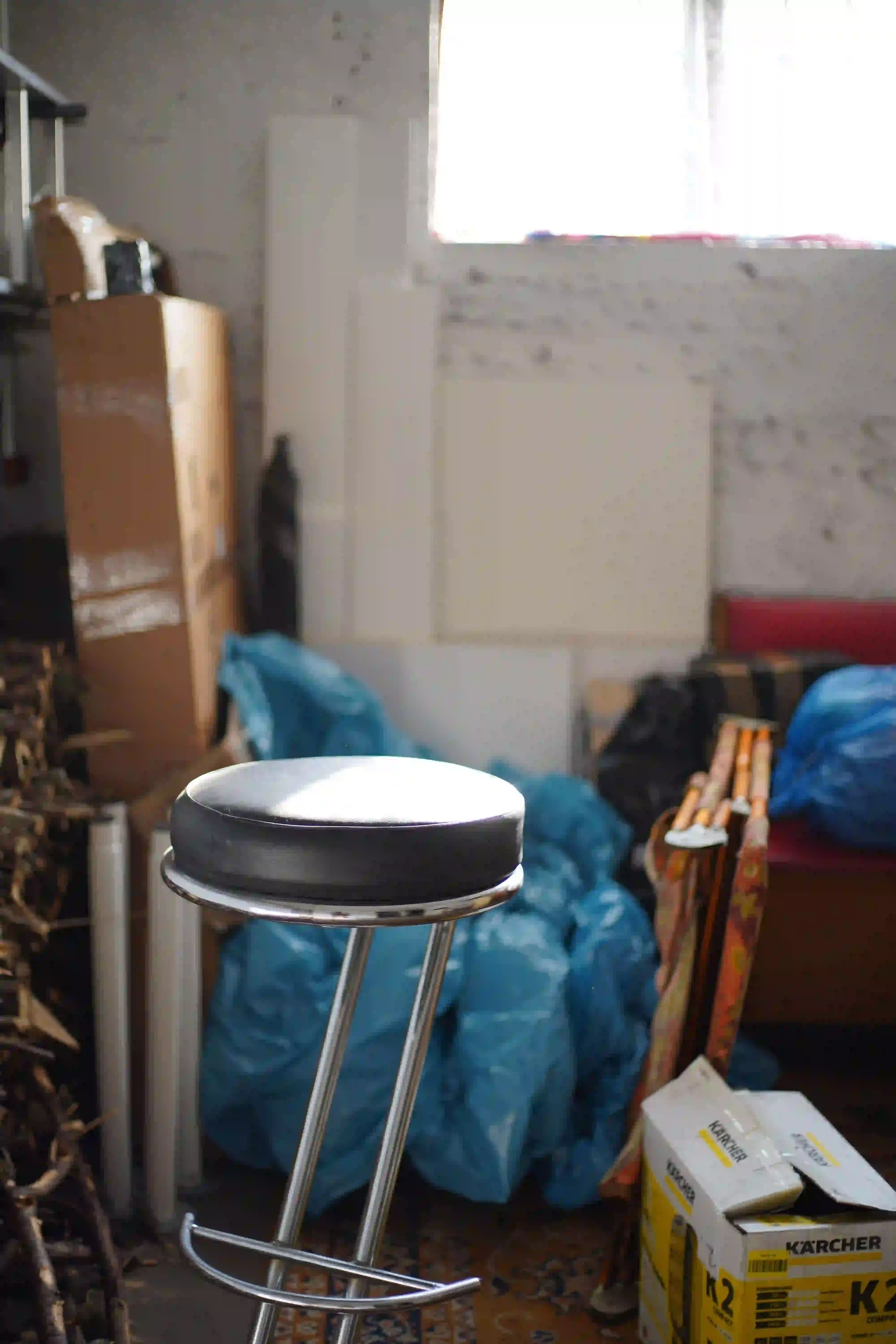 A cluttered garage before a cleanout, illustrating how volume drives junk removal pricing