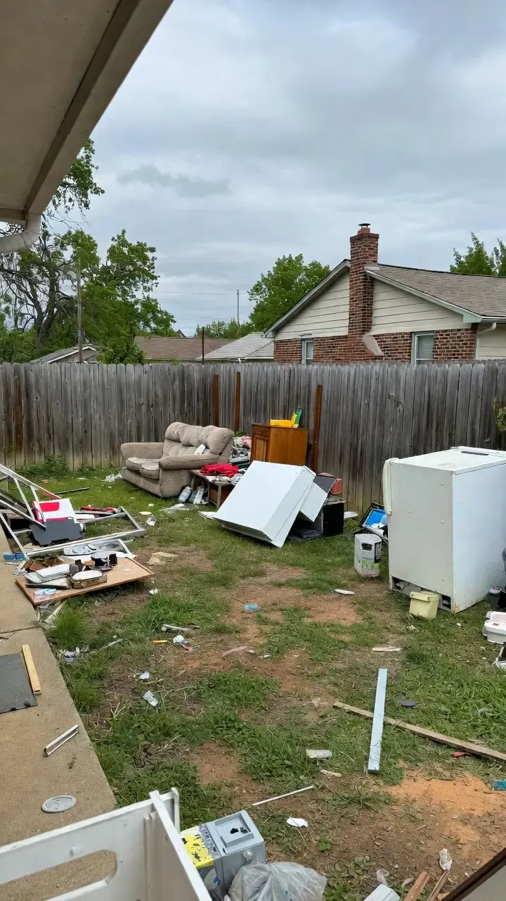 Household junk staged outside a home before a Chums Junk Removal cleanout